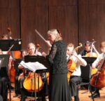 A conductor directs a symphony